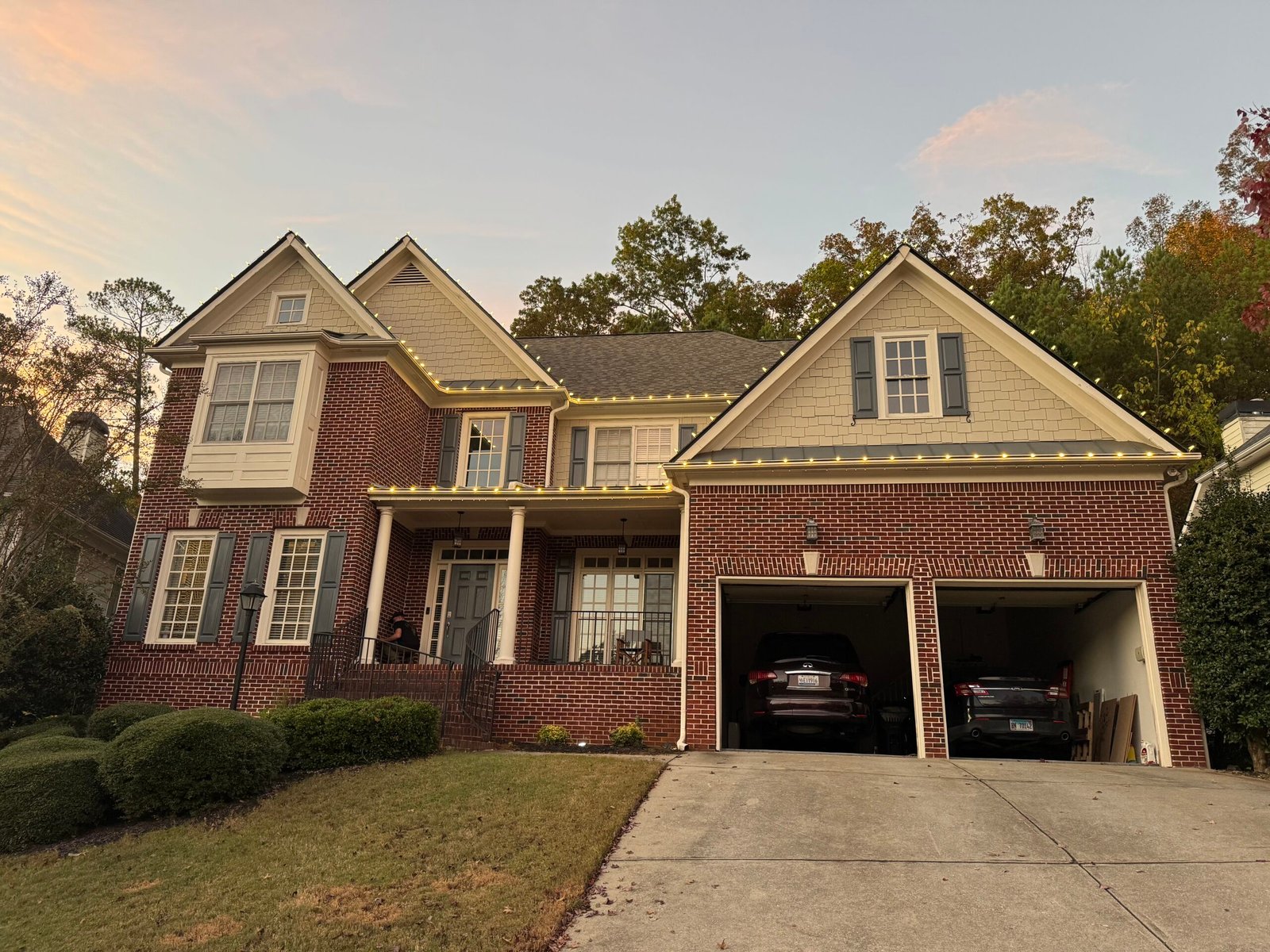 Red Clay roofline lighting installation at dusk