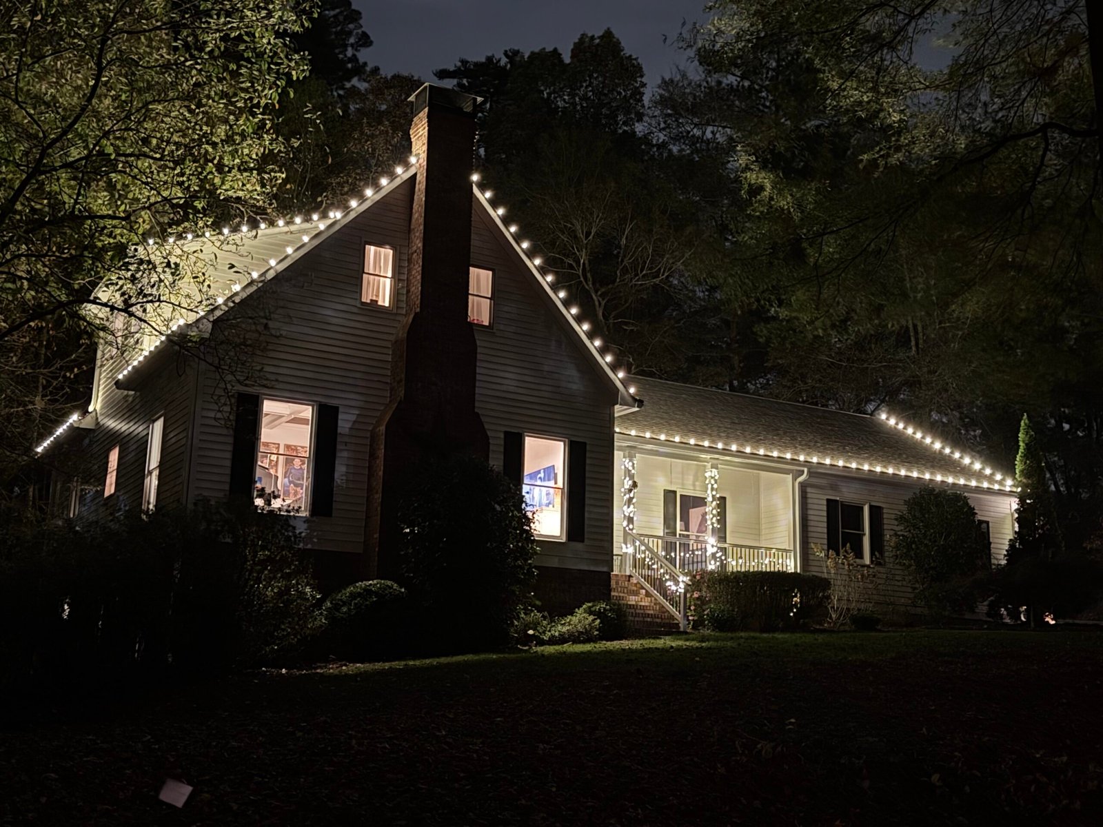 Warm white roofline lights installed by Red Clay